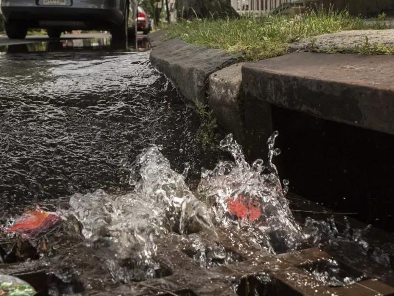 Water rushes down a stormwater drain in the West Side neighborhood of Newark, New Jersey.