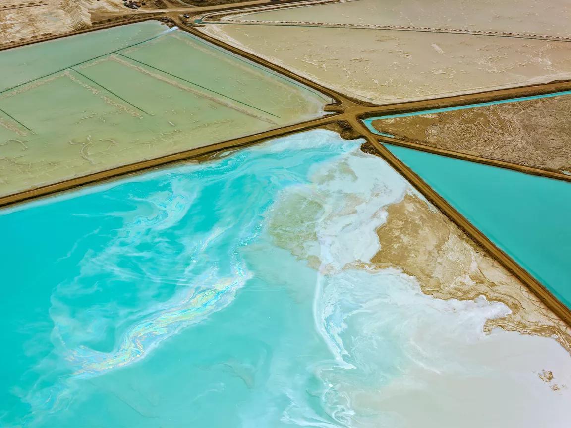 Aerial view of turquoise-colored pools of lithium brine