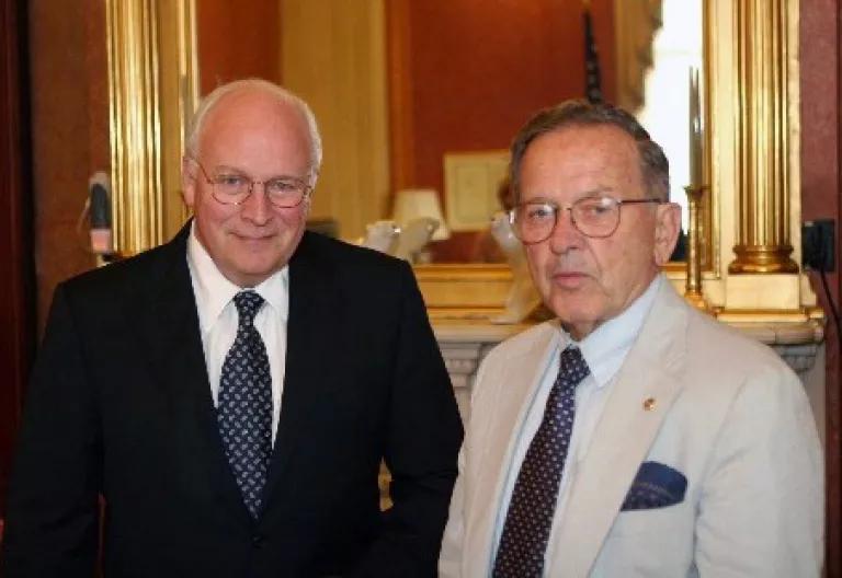 Vice President Dick Cheney and Senator Ted Stevens stand next to each other in front of a gold-framed mirror