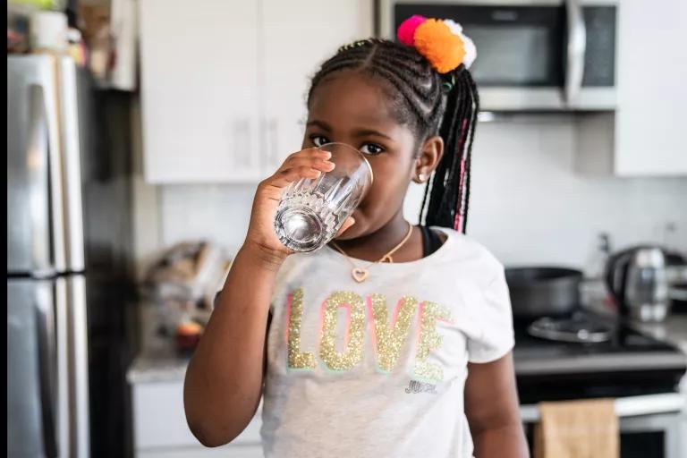 A 7-year-old drinking tap water at her home in Washington, D.C.