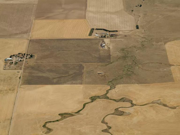 An aerial view of dry, brown farmland