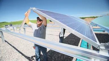 Workers installs solar panels in Minnesota 