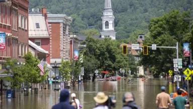 People look out over flooding on Main Street in Montpelier, Vermont.