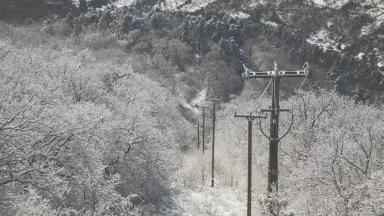 A dusting of snow covers power lines