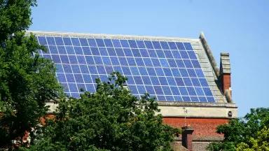Solar panels on a brick building's slanted roof