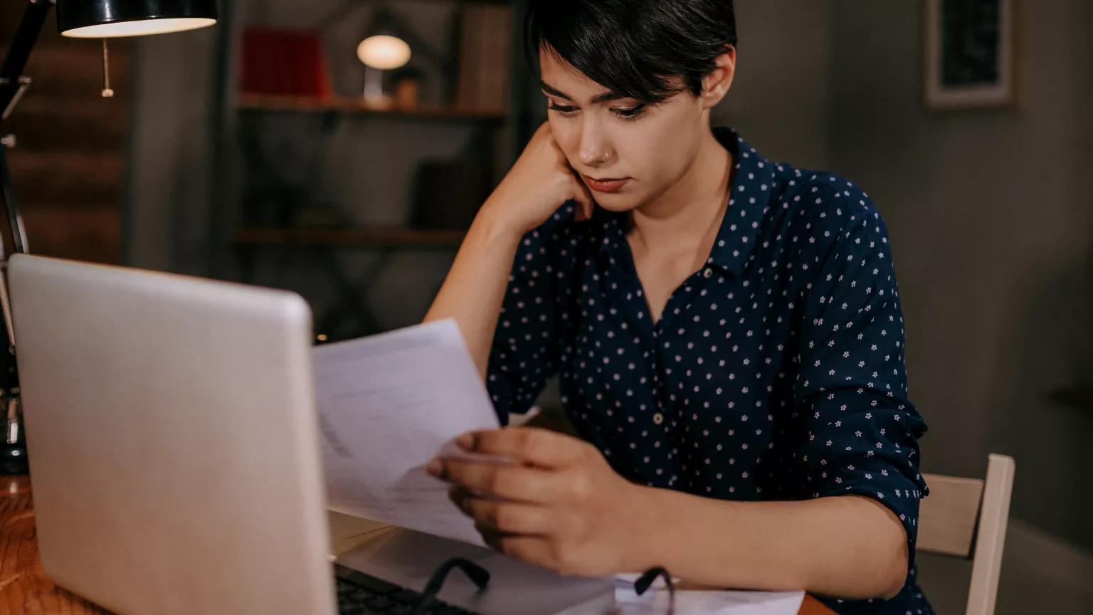 A young woman pays her utility bills.