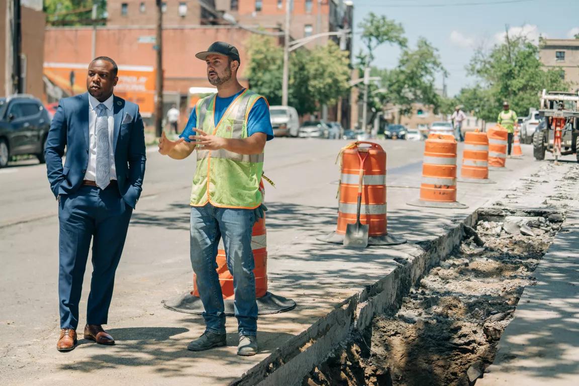 Mount Vernon's public works commissioner, Damani Bush, listens to Sam Teixeira talk about maintenance on a sewer line in Mount Vernon, New York, on June 15, 2022