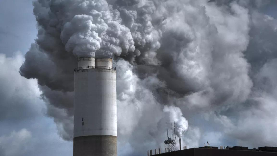 A cloud of emissions rising from a smokestack at a coal-fired power plant