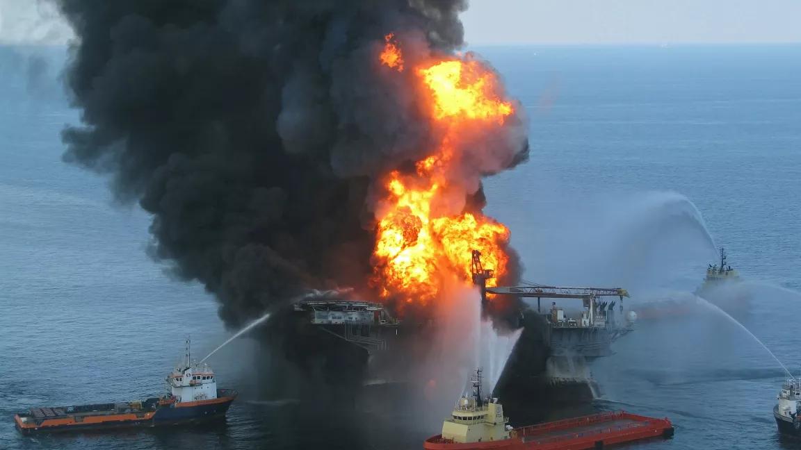 Oil platform supply boats using water cannons to fight flames and smoke rising from BP's Transocean Mobile Offshore Drilling Unit Deepwater Horizon following an explosion on the rig, located in the Gulf of Mexico