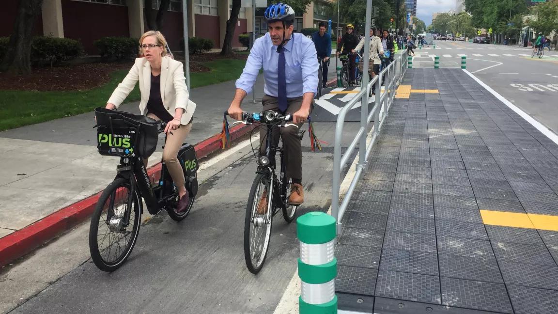 San José Mayor Sam Liccardo rides in a protected bike lane on San Fernando Street.