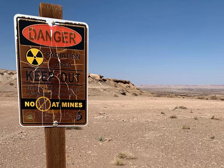 A sign warning of radiation at the site of an abandoned uranium mine