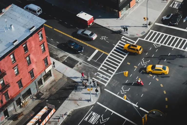 Traffic and pedestrians at an intersection in Manhattan, New York City.