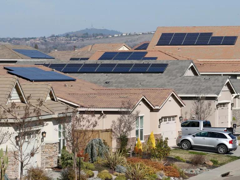 Homes with rooftop solar line a residential street
