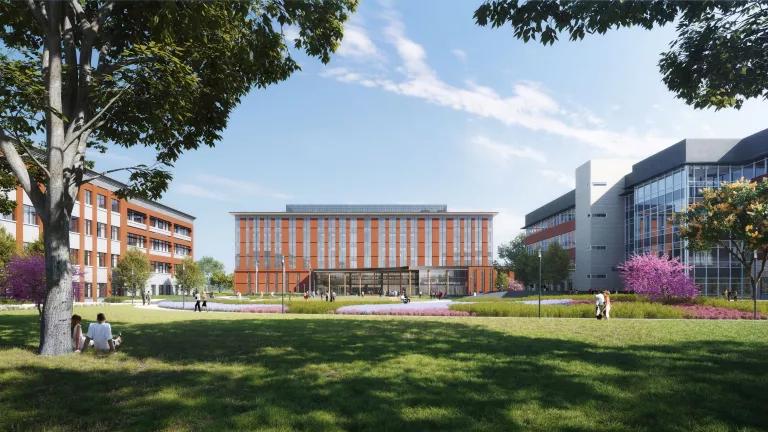 A rendering of a building surrounded green grass