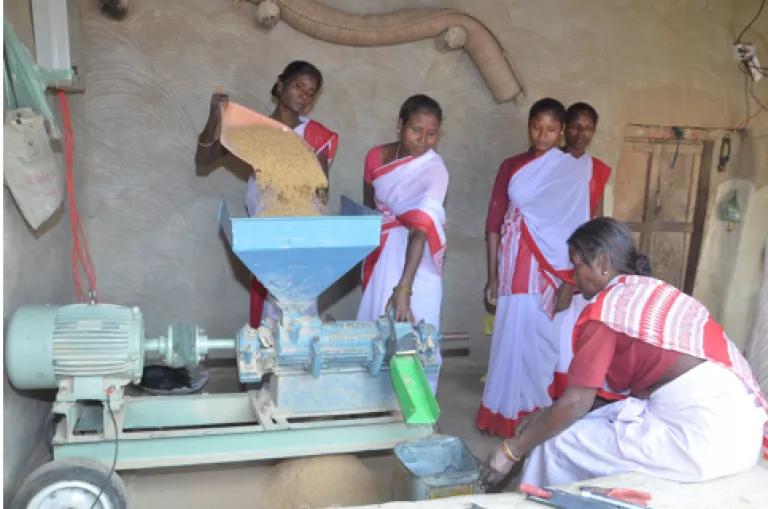 Group of women operative a milling operation powered by a solar mini-grid in India. 