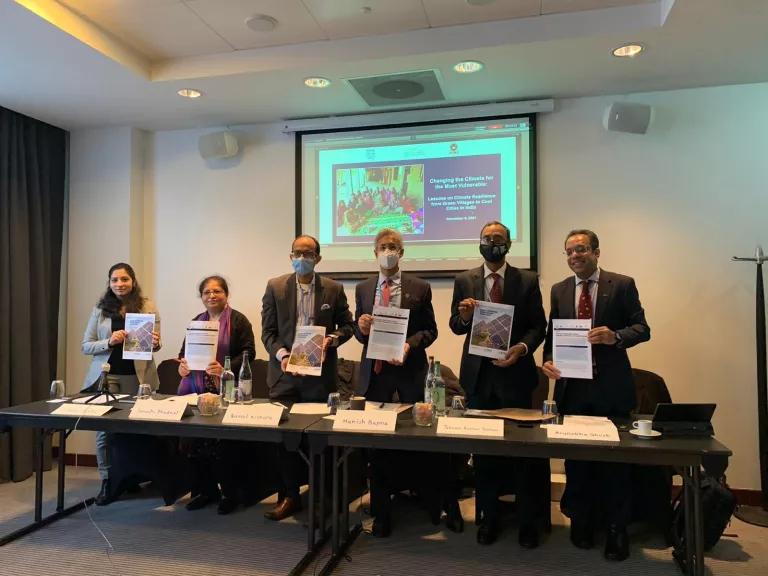 Panelists at the Side Event hold up copies of the reports released at the event