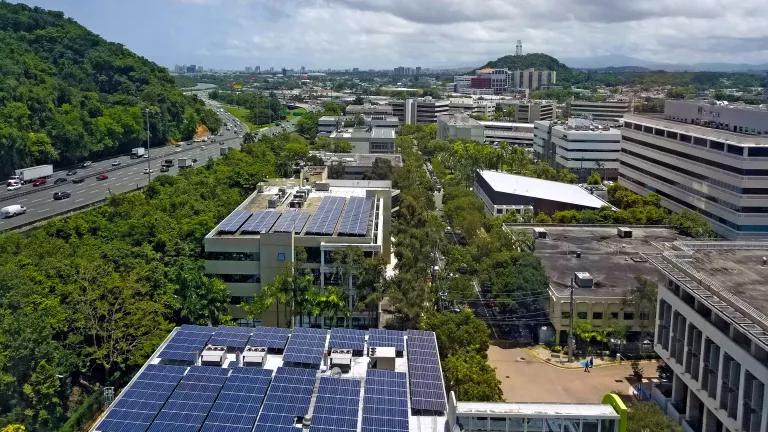 An aerial view over rooftop solar panels on a building in Guaynabo, Puerto Rico