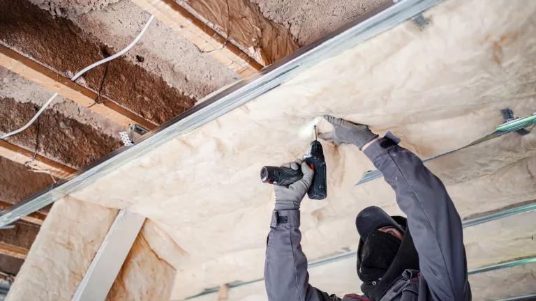 Worker installing home insulation
