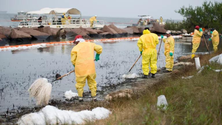 Workers clean oil spill