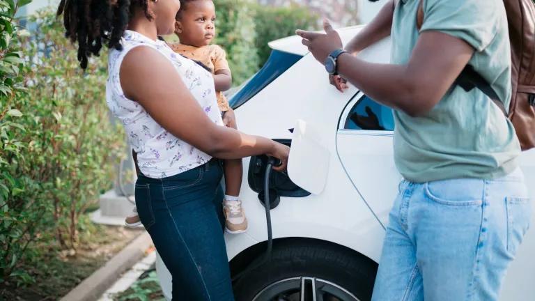A mother charging her family's electric car.