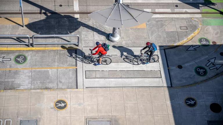An aerial view of two cyclists riding in dedicated bicycle lanes