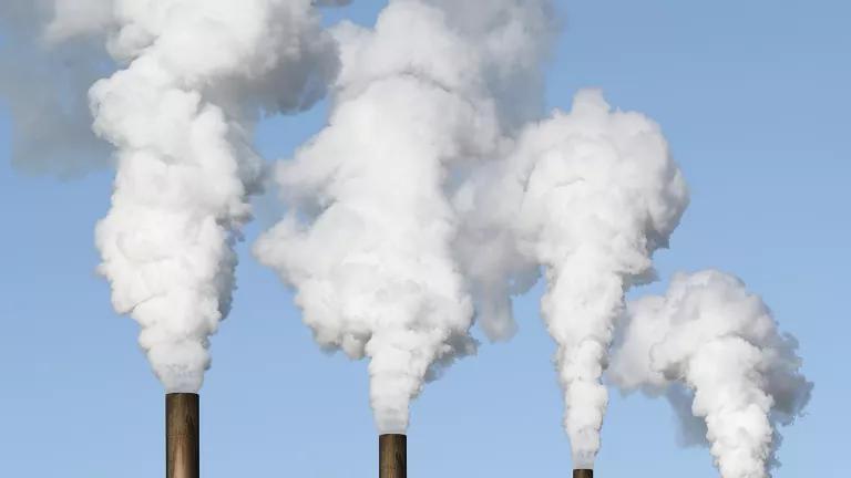 Emissions billowing from smokestacks. | iStock