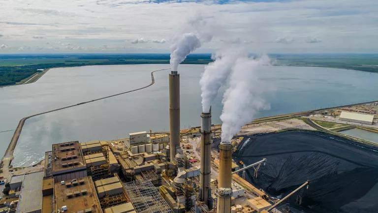 An aerial view of a coal-fired power plant, spewing smoke into the air