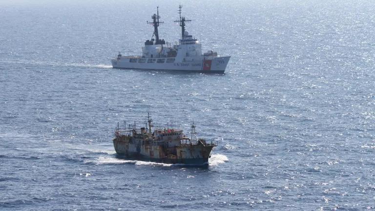 A Coast Guard ship following a suspected illegal drift net fishing boat in the North Pacific Ocean