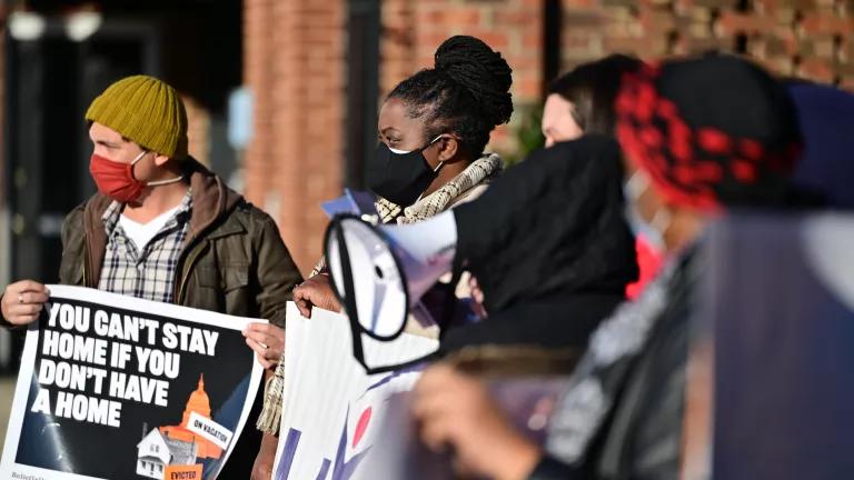 People holding protest signs at a rent relief rally in Graham, North Carolina, on January 20, 2021.