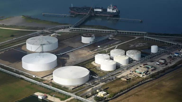 An aerial view of a large white tanks at an industrial facility