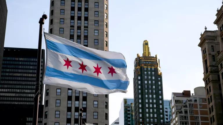 The flag of Chicago flying on a flagpole in downtown Chicago, Illinois.