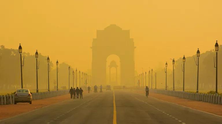 A thick smog hangs over a roadway