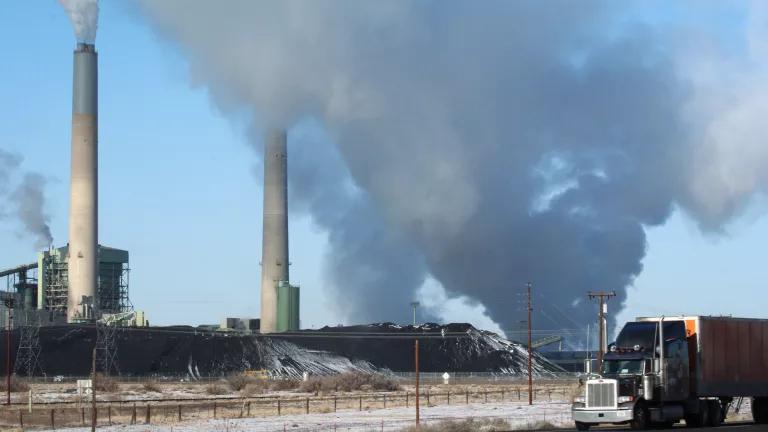 Cloud-like emissions are released by smokestacks at a coal-fired power plant