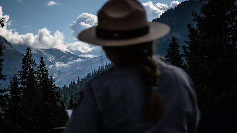 A Park Ranger talks to visitors at Jackson Glacier Overlook in Glacier National Park, Montana.