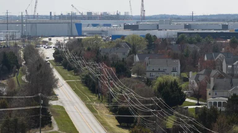 Power lines connect to a data center beside a residential neighborhood in Ashburn, Virginia, on March 12, 2026.

Data centers require large amounts of natural resources, including water, to run. Northern Virginia has the largest concentration of data centers in the world, managing roughly 70% of global internet traffic.
