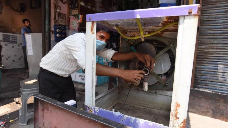 Electrician Arjun Kumar repairs a cooler at his shop at Shakarpur School Block in New Delhi, India, on April 28, 2020.