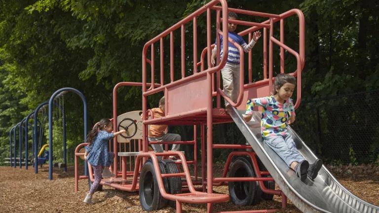 Children playing on a playground in a public park.