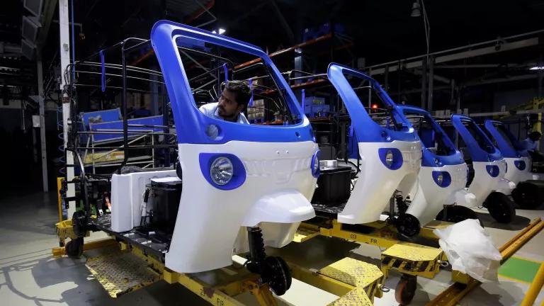 An employee working on the assembly line of the Mahindra Treo e-auto factory in Bengaluru, India.
