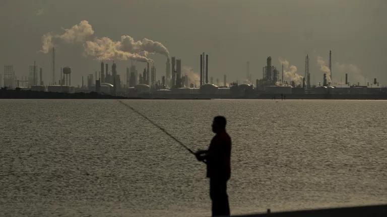 People fish along the Texas City Dike across from the refineries inside the Texas City industrial complex, including Marathon and Valero, May 2021.