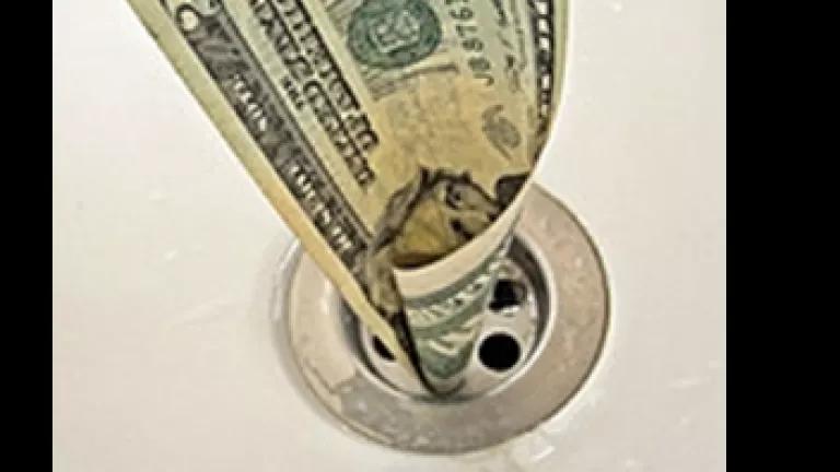 Money down drain.png