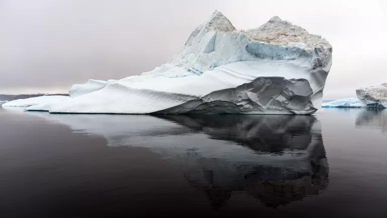 A portion of a large chunk of ice site above the surface of water