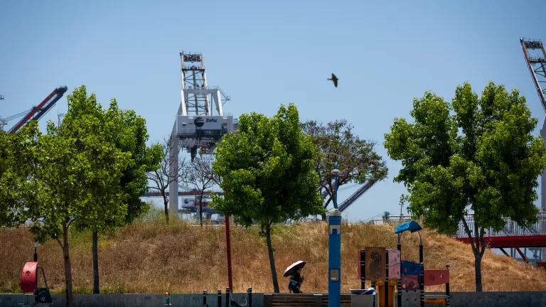 A family playing at the playground in Wilmington Waterfront Park near the Port of Los Angeles in Los Angeles, California, on June 26, 2024.

Residents of Wilmington, Signal Hill and Long Beach suffer damaging health impacts from the toxic fumes of diesel trucks and various local oil infrastructure, including drilling sites and the nearby Valero Wilmington Refinery.