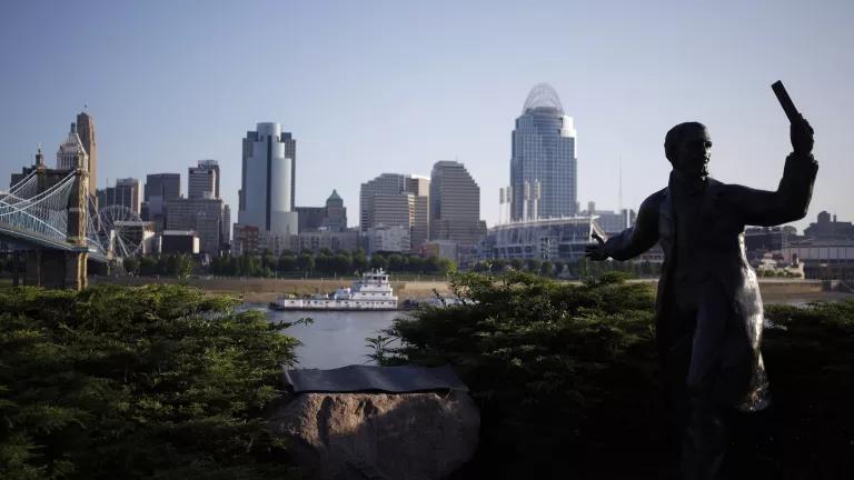 A city skyline with a bridge and river visible in the foreground