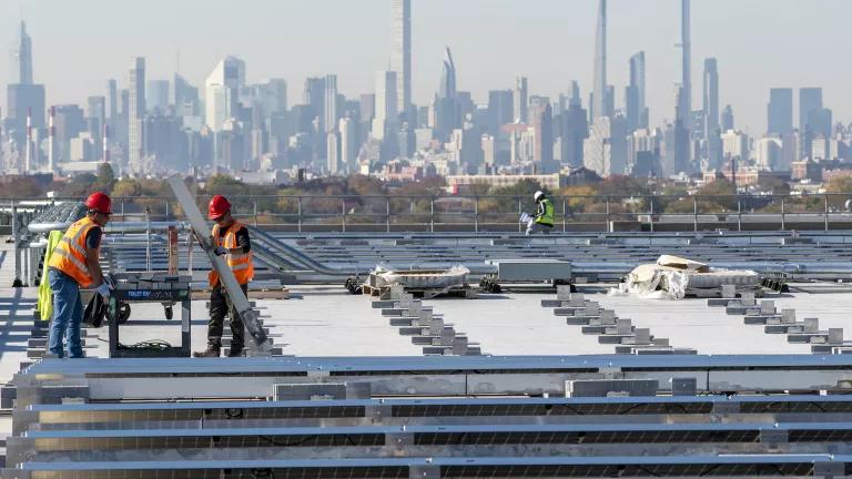 Electricians with IBEW Local 3 installing solar panels at LaGuardia Airport in Queens, New York City.