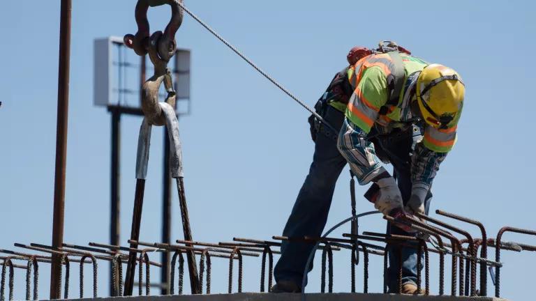 Construction worker installing steel reinforcement bars