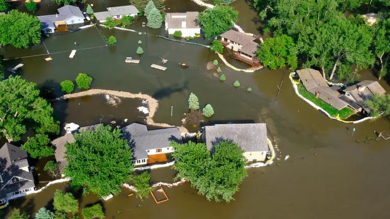 An aerial view of a neighborhood of homes sitting in floodwaters
