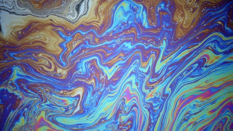 A close-up view of multicolor swirls in a liquid