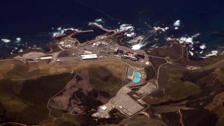 An aerial view of a power plant situated on a coastline
