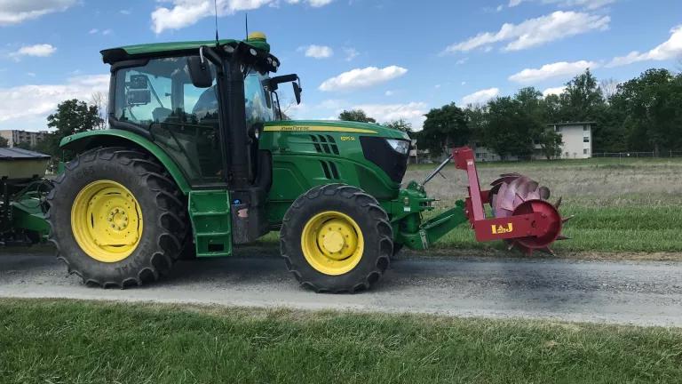 Tractor with roller crimper attached to front