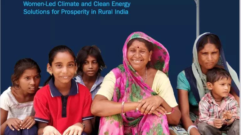 Cover of the Hariyali Green Villages 2022 report, with women in a village smiling at camera surrounded by several small children and solar panels